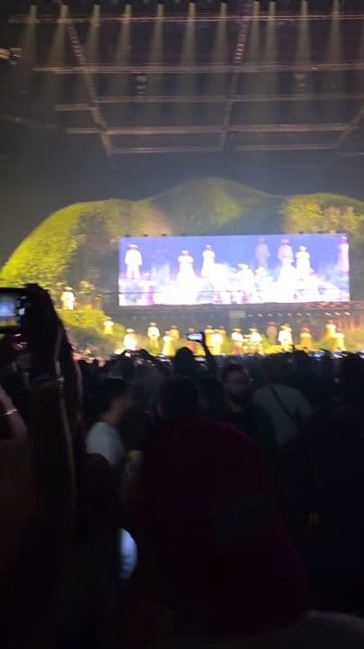 Crowd enjoying a live concert beneath the stage lights